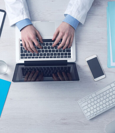 Image showing two hands working on laptop on a table